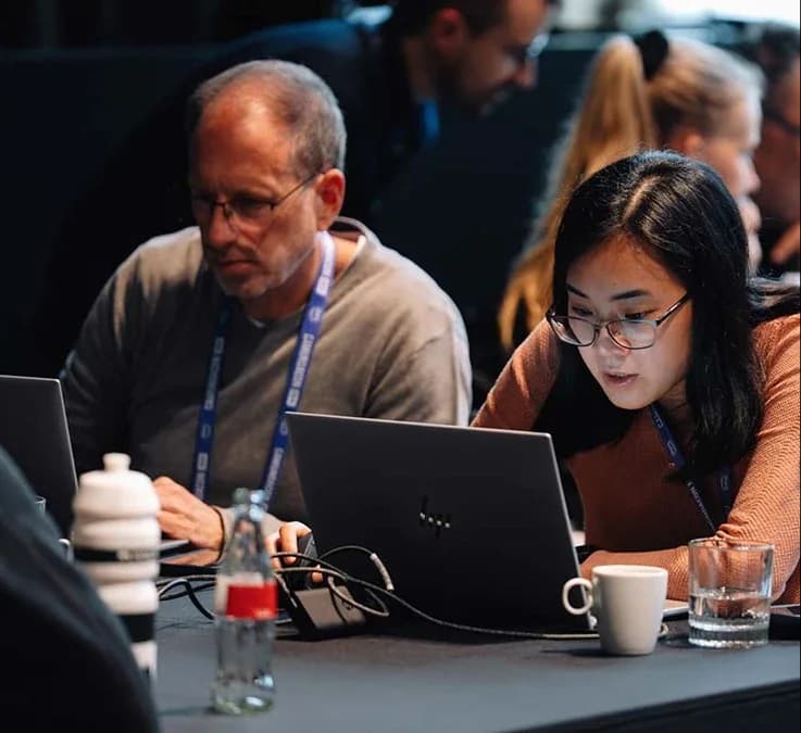 Attendees working on laptops in a hands-on session
